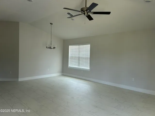 a view of a room with a window and a fan