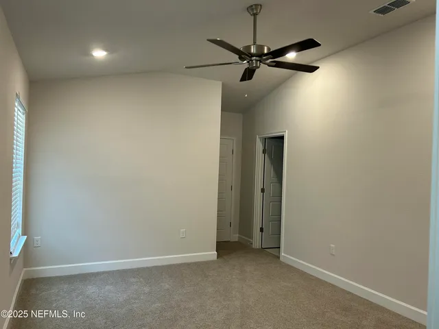 a view of a room with a ceiling fan