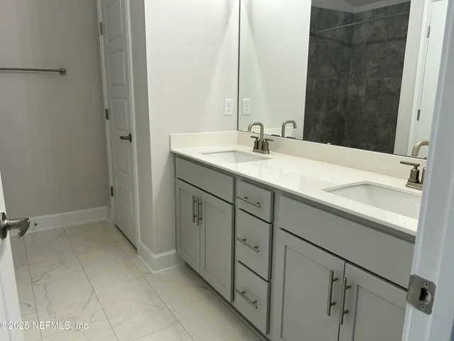 a bathroom with a sink and a mirror