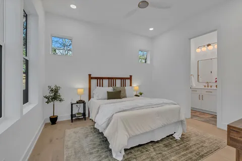 a bathroom with a sink vanity mirror and toilet