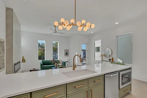 a kitchen that has a refrigerator a table and chairs in it