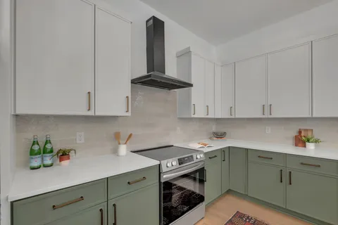 a living room with furniture and kitchen view