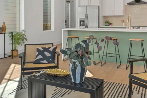 a living room with furniture a rug and a window