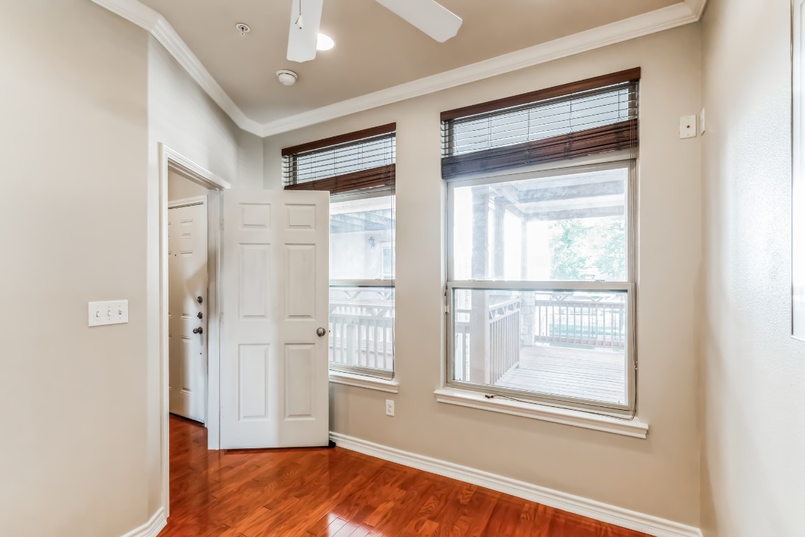 305 East 31st Street, Unit 6 Austin, TX 78705 - Photo 19 of 26 a view of an empty room with wooden floor and a window