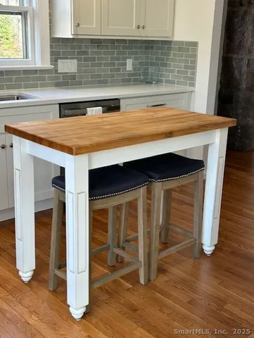 a kitchen with granite countertop a stove and a sink