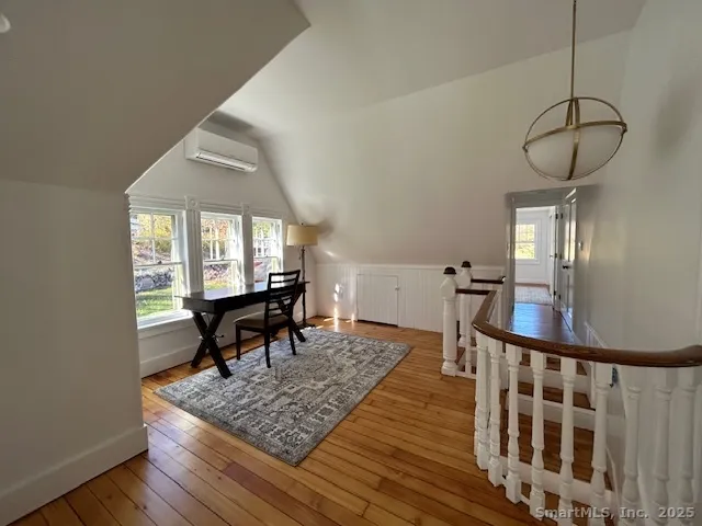 a view of a livingroom with furniture hardwood floor and a chandelier