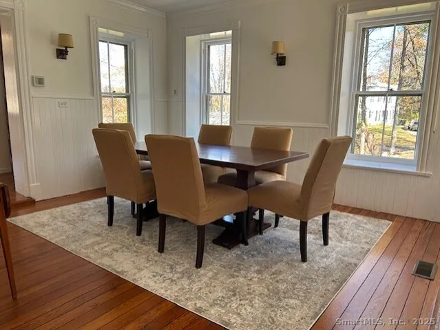 a view of a dining room with furniture window and wooden floor
