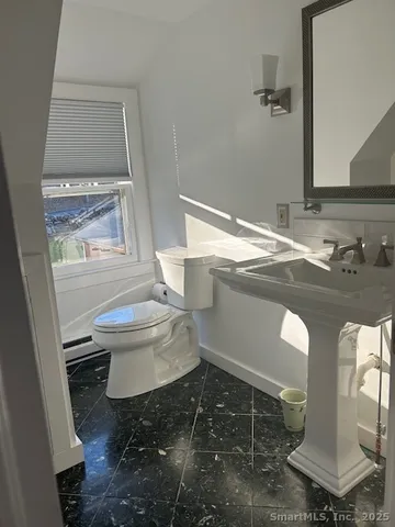 a bathroom with a sink toilet and mirror