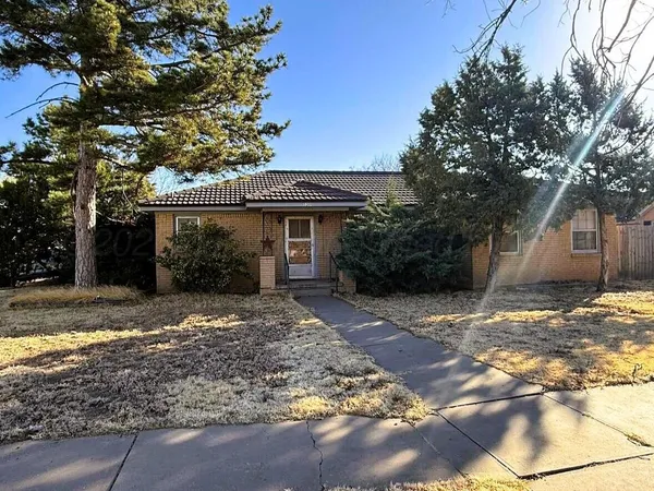 a view of a house with a tree in the yard