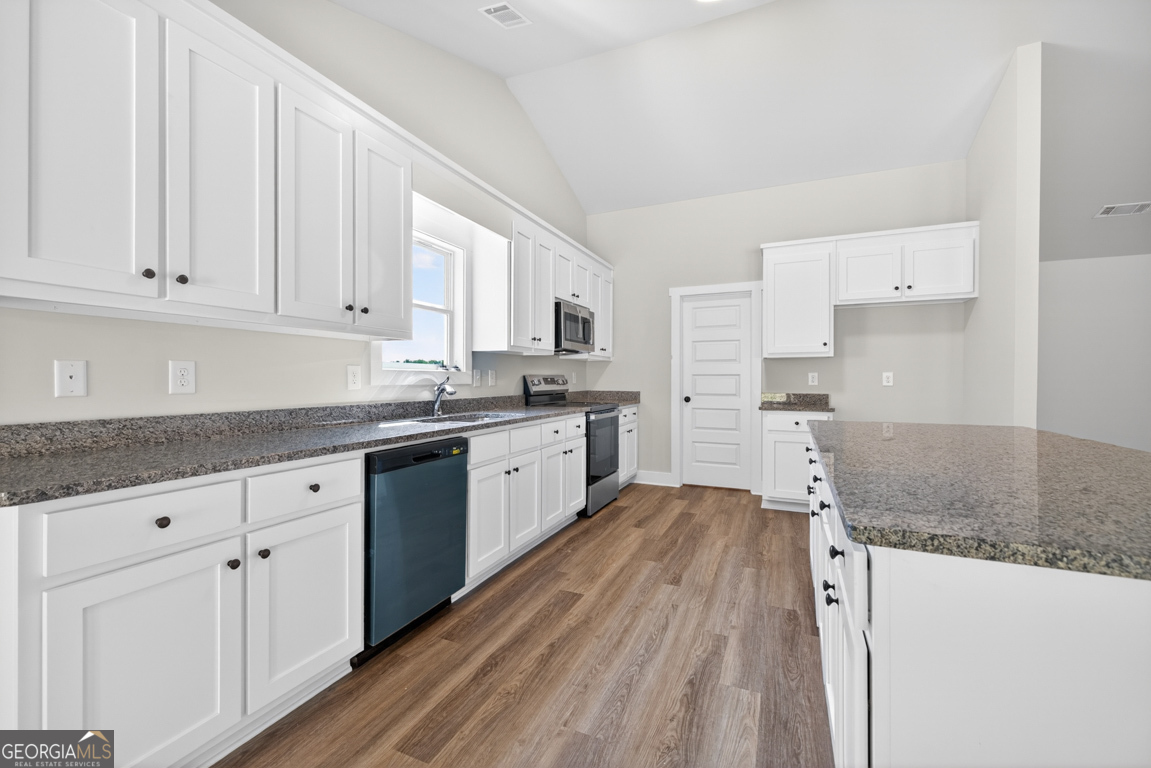 206 Airport Road, Unit 11 Canon, GA 30520 - Photo 12 of 34 a kitchen with granite countertop a sink stainless steel appliances and white cabinets
