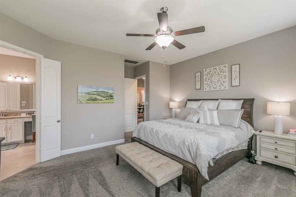 14804 Cedar Flat Way Fort Worth, TX 76262 - Photo 15 of 35 a bedroom with a large bed and a chandelier