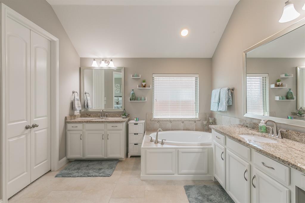 14804 Cedar Flat Way Fort Worth, TX 76262 - Photo 17 of 35 a bathroom with a granite countertop double vanity sink a mirror and a bathtub