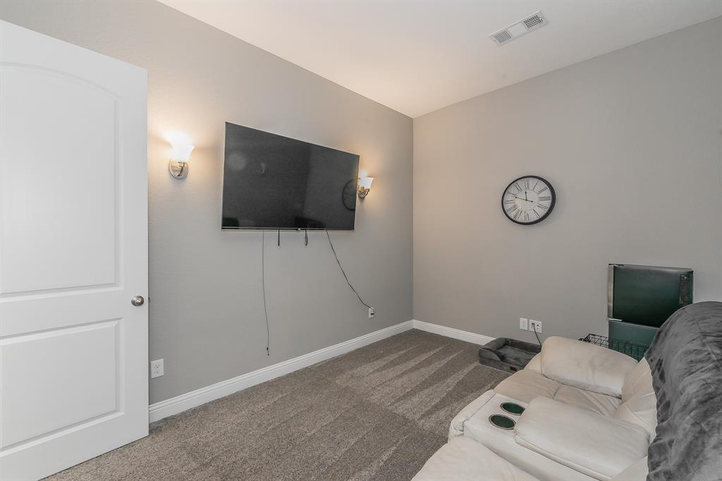 14804 Cedar Flat Way Fort Worth, TX 76262 - Photo 26 of 35 a living room with furniture and a flat screen tv