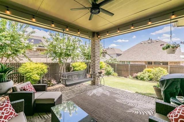 a bedroom with furniture and a large window