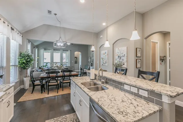 a large kitchen with a table and chairs