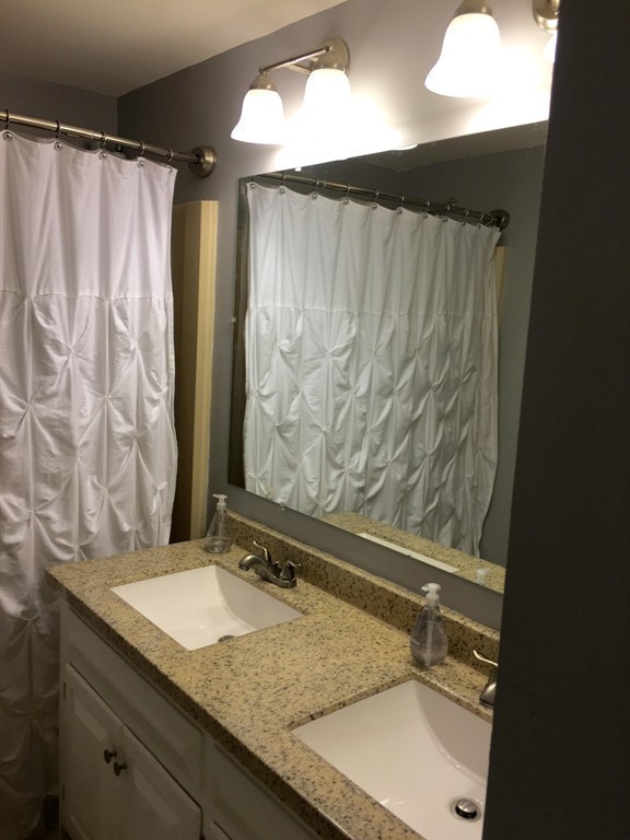 61 Tioga Street Springfield, MA 01128 - Photo 14 of 20 a bathroom with a granite countertop sink and a mirror