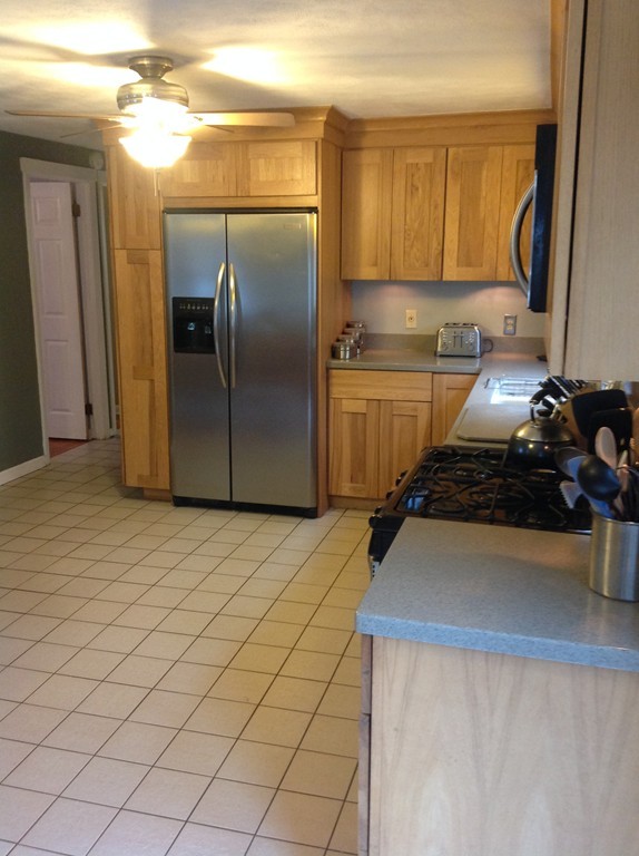 61 Tioga Street Springfield, MA 01128 - Photo 5 of 20 a kitchen with granite countertop a sink and a refrigerator