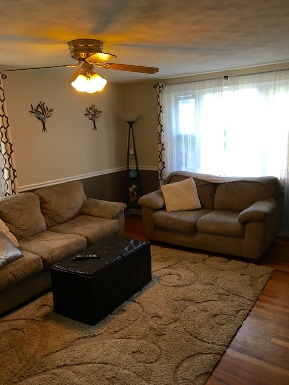 61 Tioga Street Springfield, MA 01128 - Photo 6 of 20 a living room with furniture and a large mirror