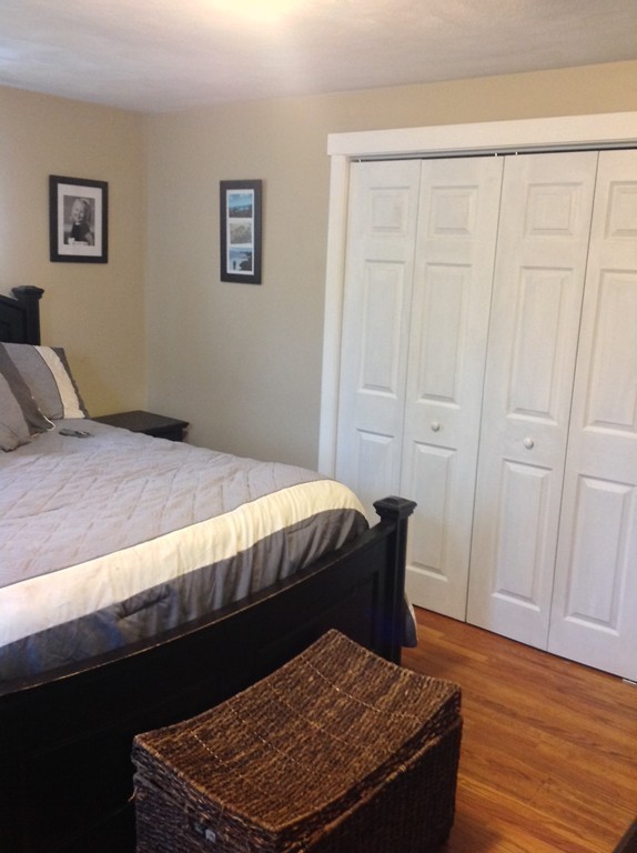 61 Tioga Street Springfield, MA 01128 - Photo 10 of 20 a bedroom with a bed and wooden floor