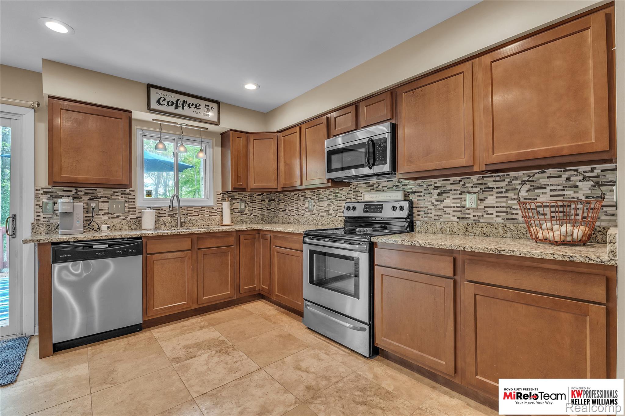 10191 Judd Road Willis, MI 48191 - Photo 7 of 39 Kitchen with wood finish cabinetry, stainless steel appliances, light stone counters, and backsplash
