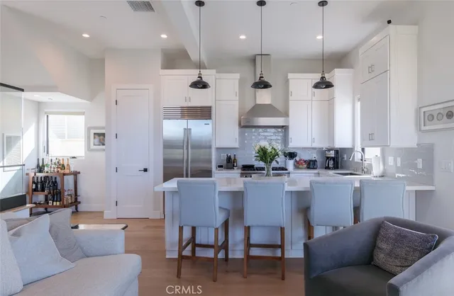 a large kitchen with a table and chairs