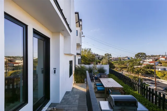 a view of a balcony dining area and furniture