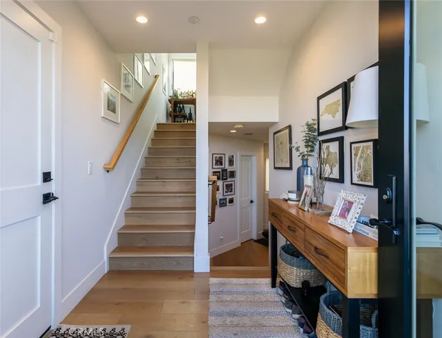 a view of entryway and hall with wooden floor