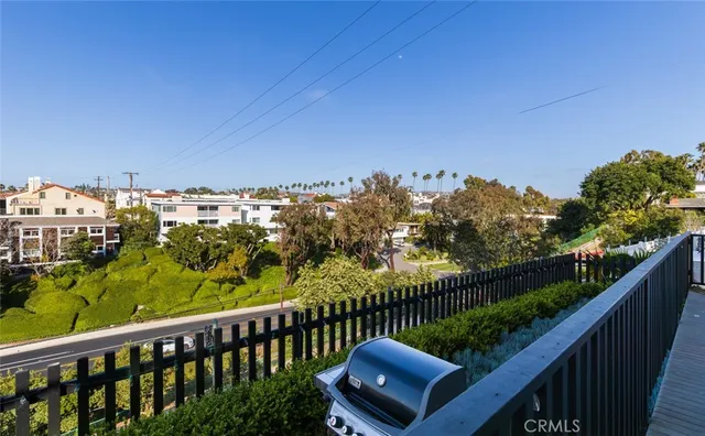 a view of a balcony with wooden fence and floor
