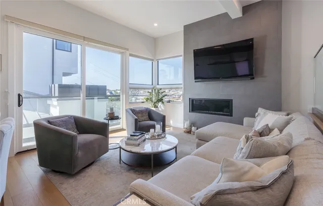 a living room with furniture a flat screen tv and a fireplace
