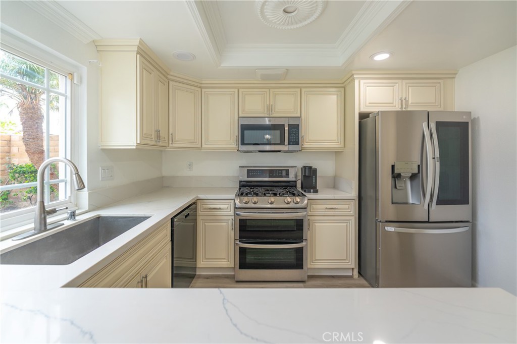 31 Carson Irvine, CA 92620 - Photo 13 of 50 a kitchen with stainless steel appliances granite countertop a refrigerator sink and stove
