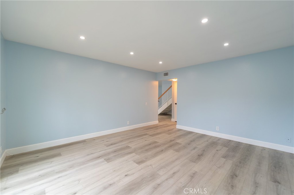 31 Carson Irvine, CA 92620 - Photo 9 of 50 an empty room with wooden floor and white walls