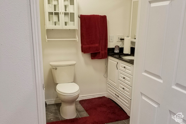 2855 South 1000 West Perry, UT 84302 - Photo 70 of 142 Half bath with dark tile patterned flooring and vanity