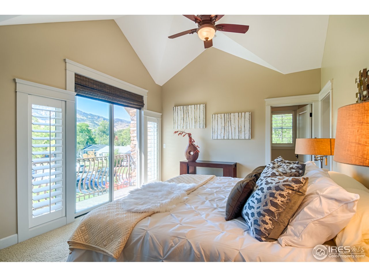 1412 North Street Boulder, CO 80304 - Photo 19 of 39 a bedroom with a large bed and a chandelier