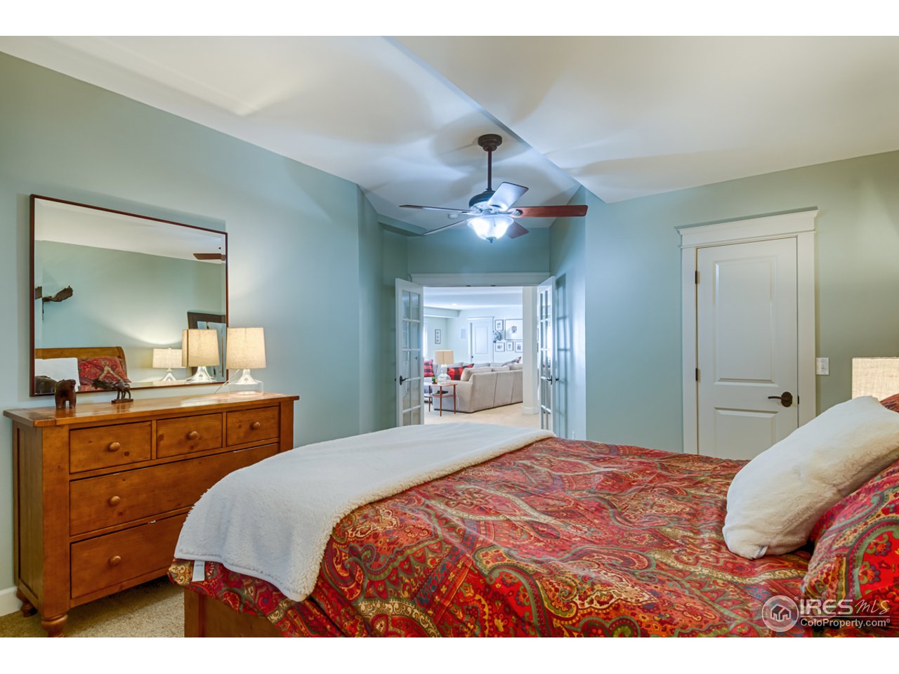 1412 North Street Boulder, CO 80304 - Photo 30 of 39 a bedroom with a large bed and a chandelier