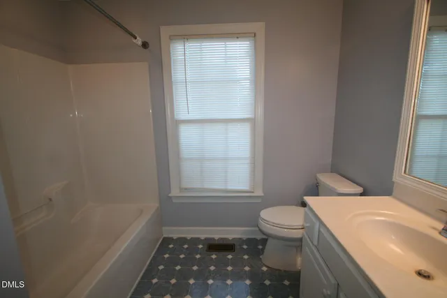 a bathroom with a sink a toilet and window