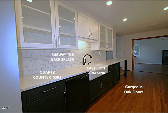 a kitchen with granite countertop stove top oven and cabinets