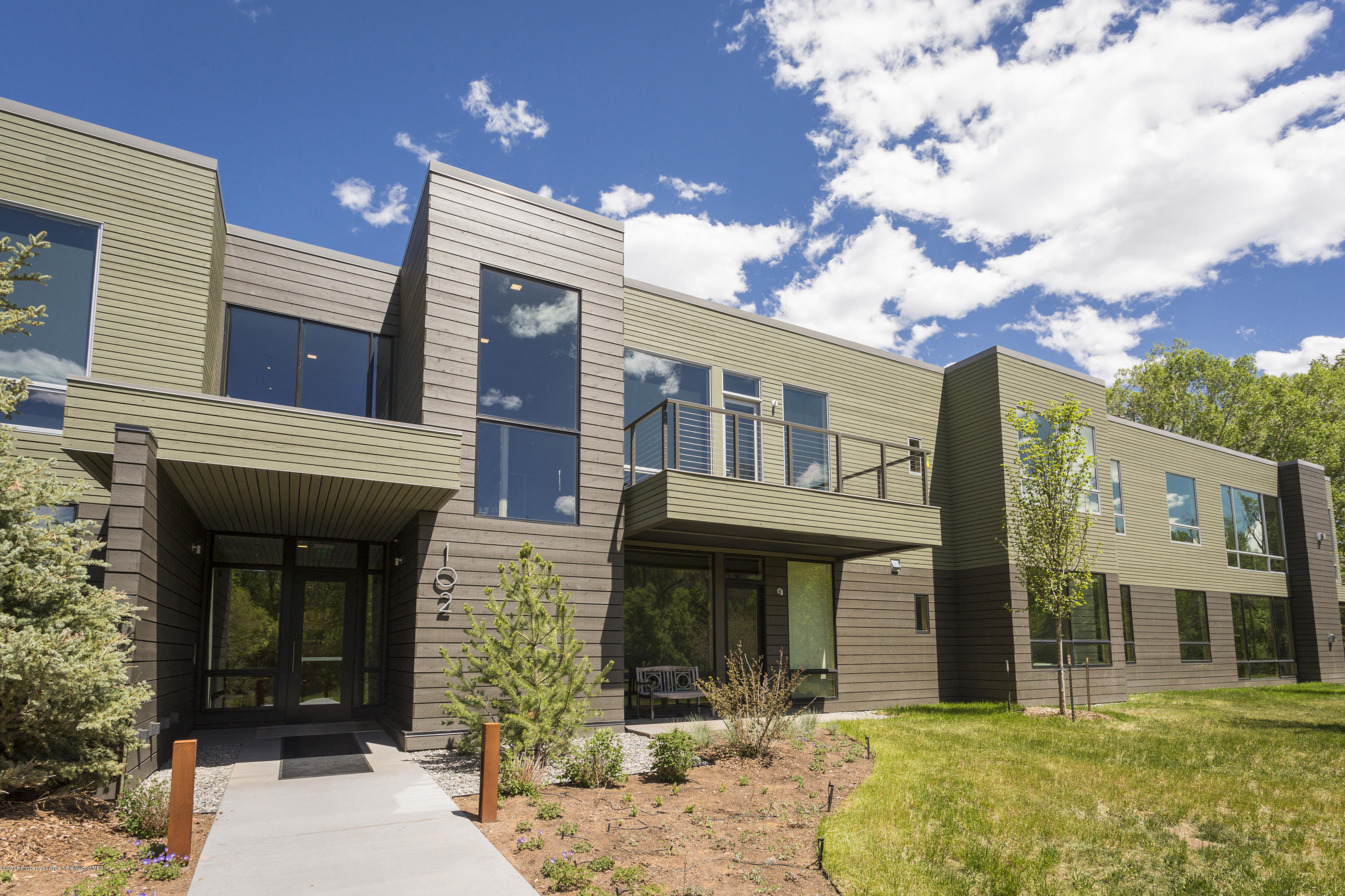 100 Evans Road, Unit 103 Basalt, CO 81621 - Photo 22 of 24 front view of a brick house with a yard