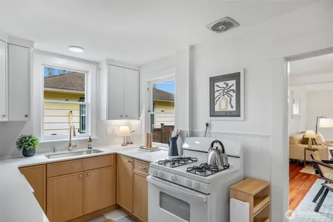 a kitchen with stainless steel appliances granite countertop a stove and a sink