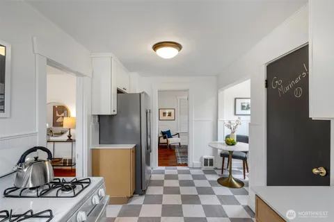 a kitchen with a refrigerator and a stove top oven