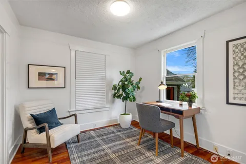 a living room with furniture and a potted plant
