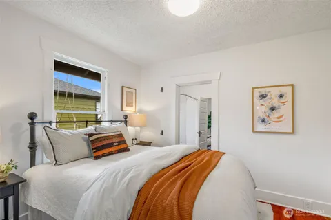 a bedroom with bed and a window