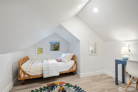 a view of a room with wooden floor table and chairs