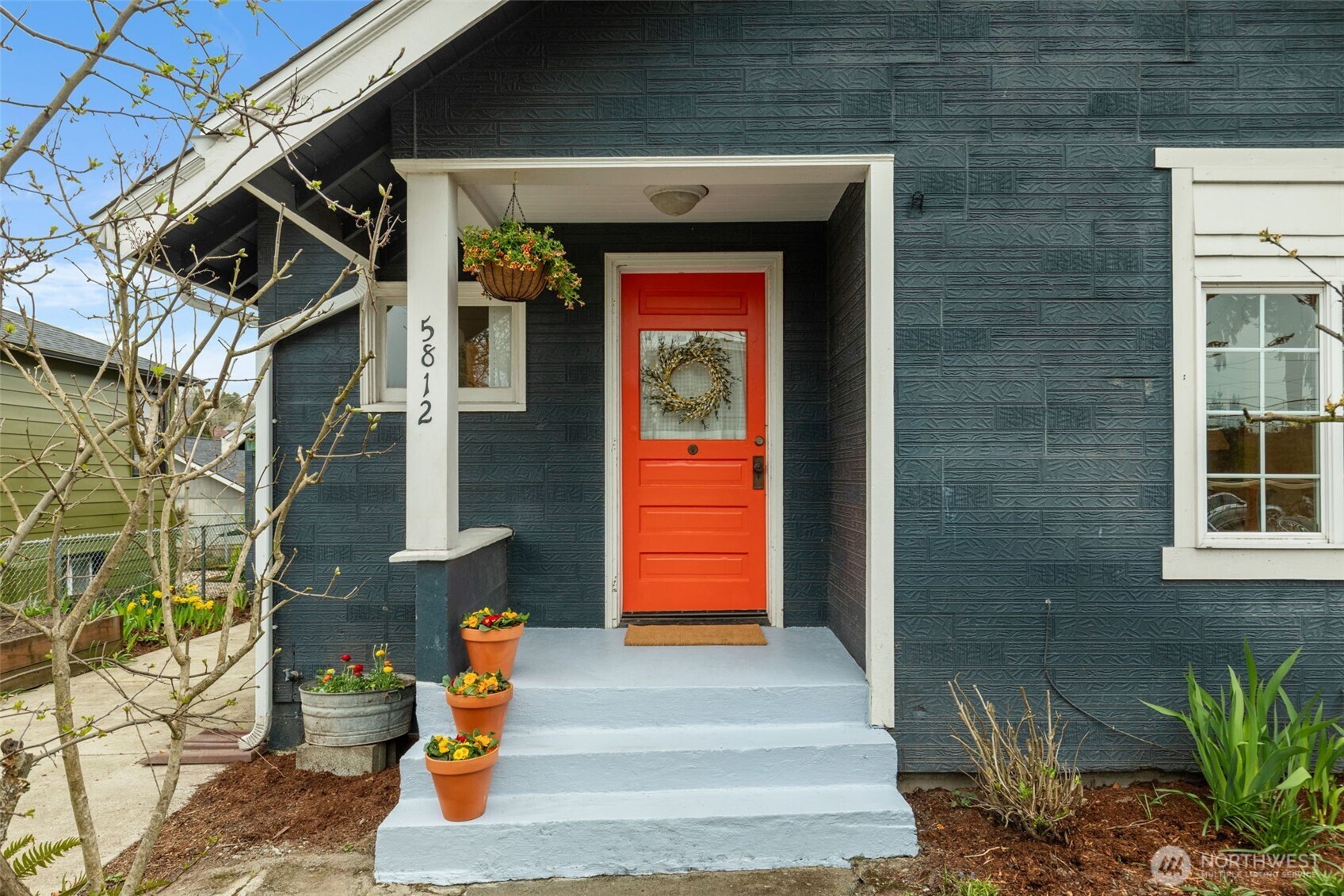 5812 46th Avenue South Seattle, WA 98118 - Photo 4 of 40 a front view of a house with a garden