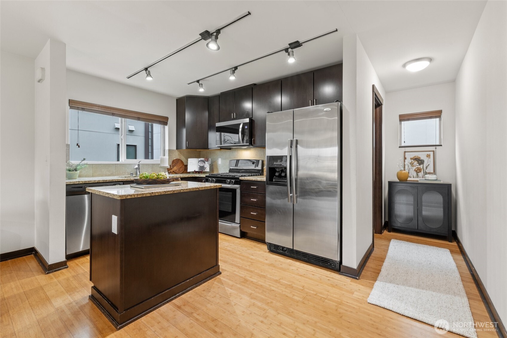 2516 Yale Avenue East, Unit C Seattle, WA 98102 - Photo 6 of 37 a kitchen with stainless steel appliances granite countertop a refrigerator a stove a sink and a oven