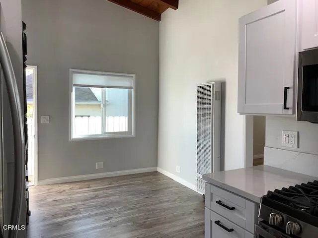 a kitchen with stainless steel appliances granite countertop a stove and a refrigerator