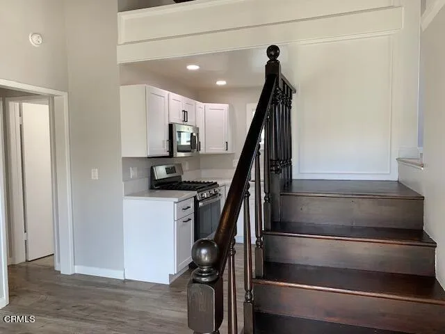 a view of entryway and hall with wooden floor