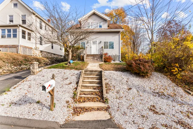 a front view of a house with a yard