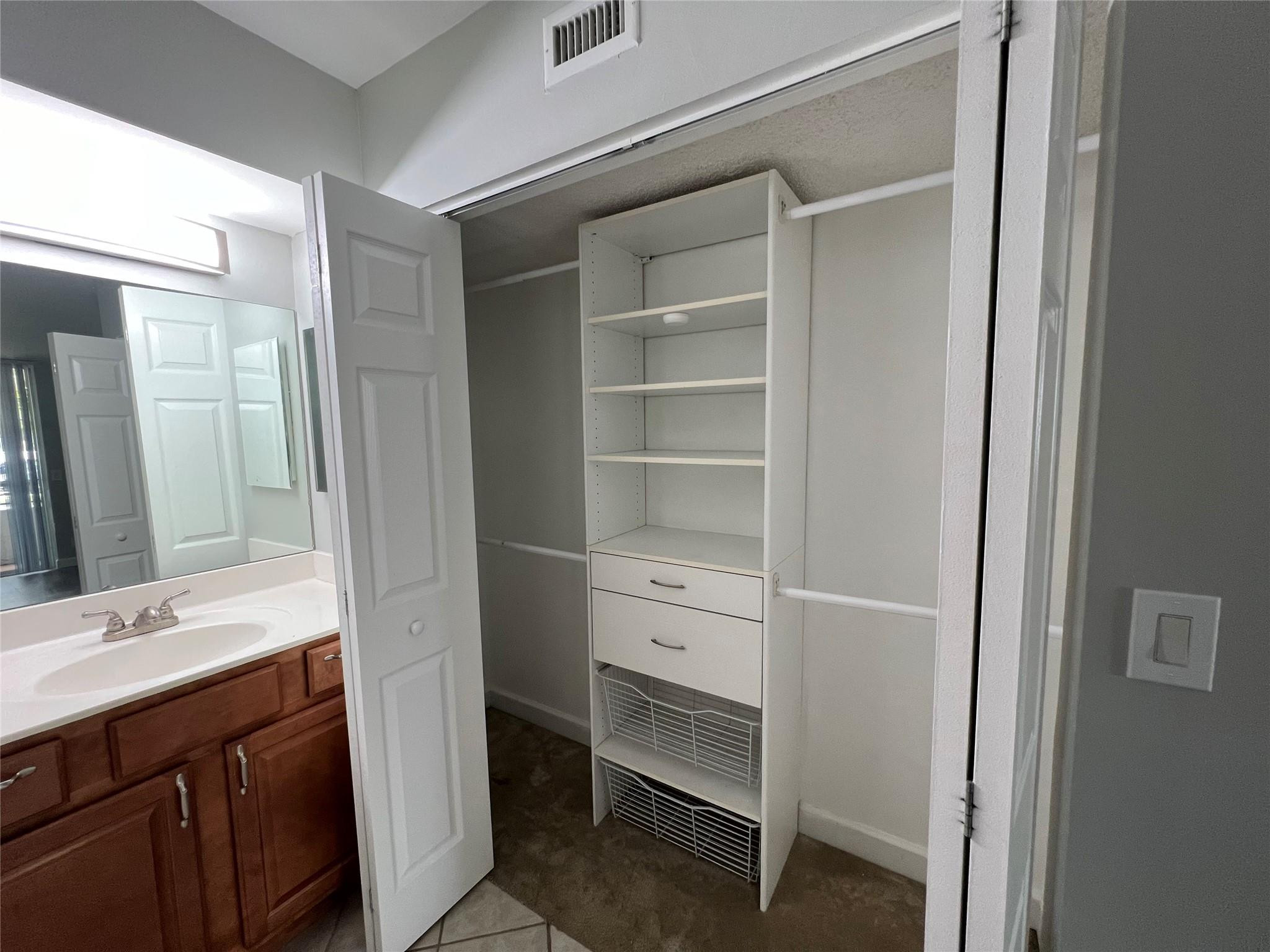 921 Lyons Road, Unit 3105 Coconut Creek, FL 33063 - Photo 16 of 28 a bathroom with a sink vanity and a mirror