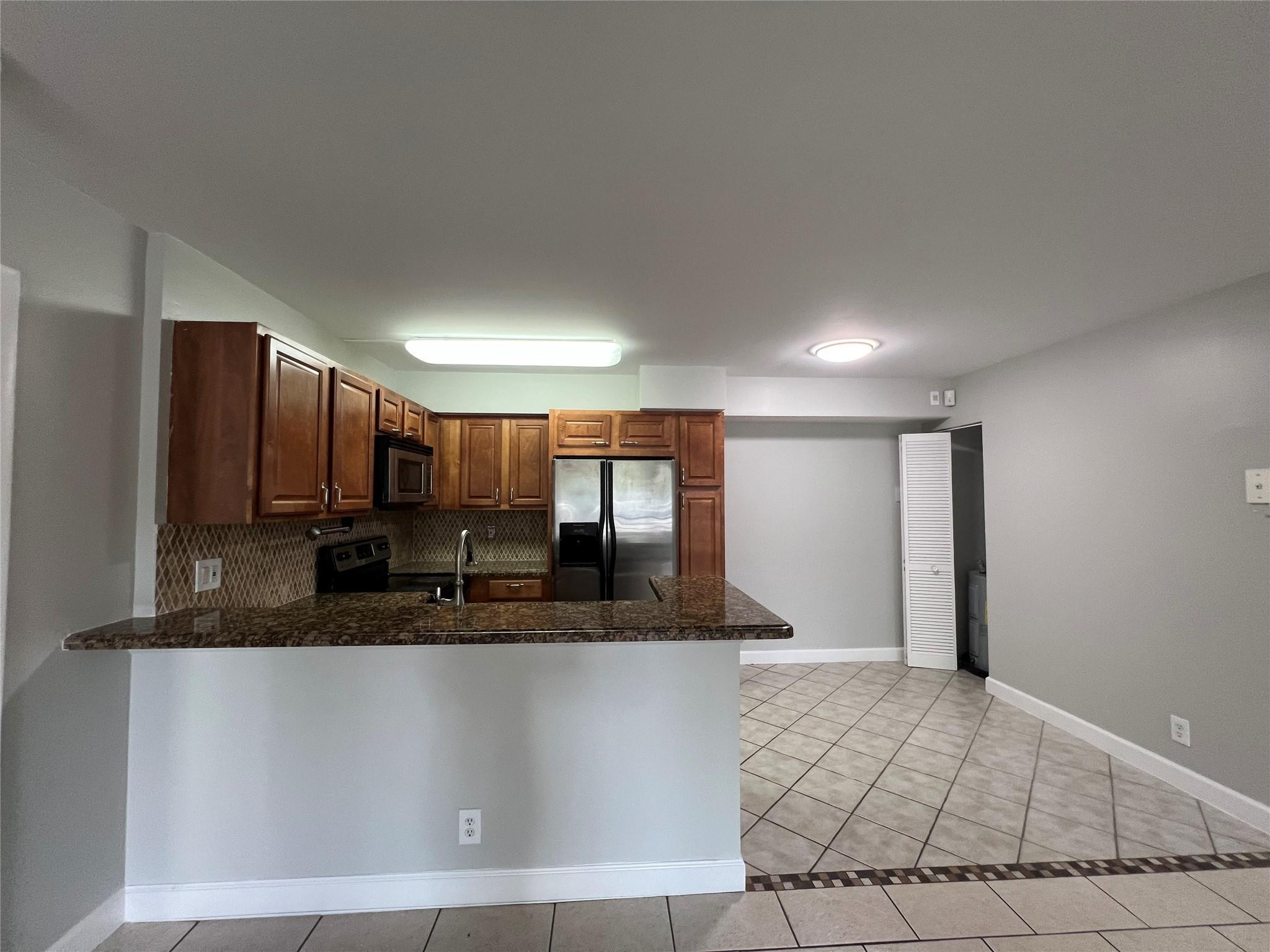 921 Lyons Road, Unit 3105 Coconut Creek, FL 33063 - Photo 17 of 28 a large bathroom with a granite countertop sink a mirror and a shower