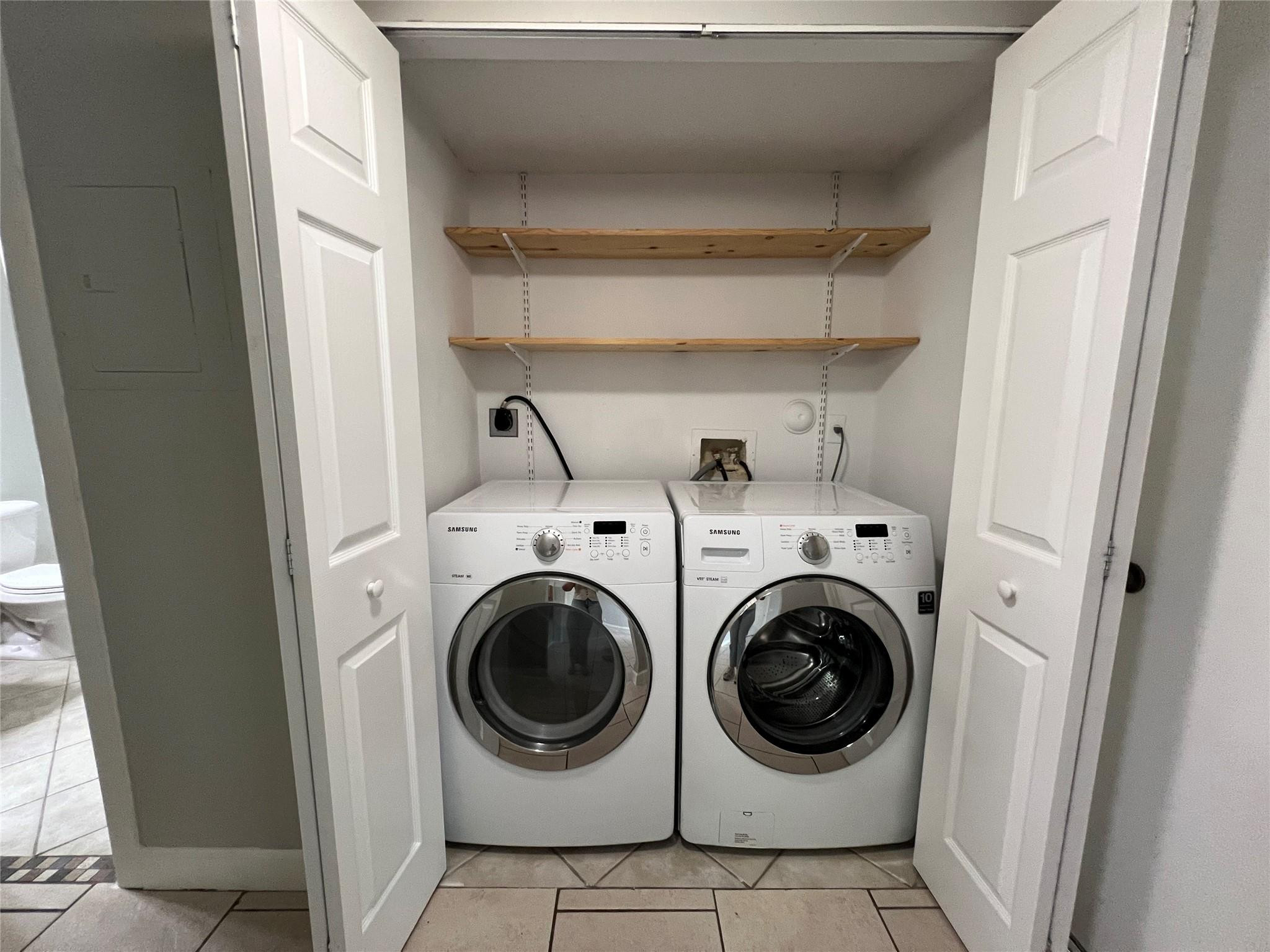 921 Lyons Road, Unit 3105 Coconut Creek, FL 33063 - Photo 20 of 28 a utility room with dryer and washer
